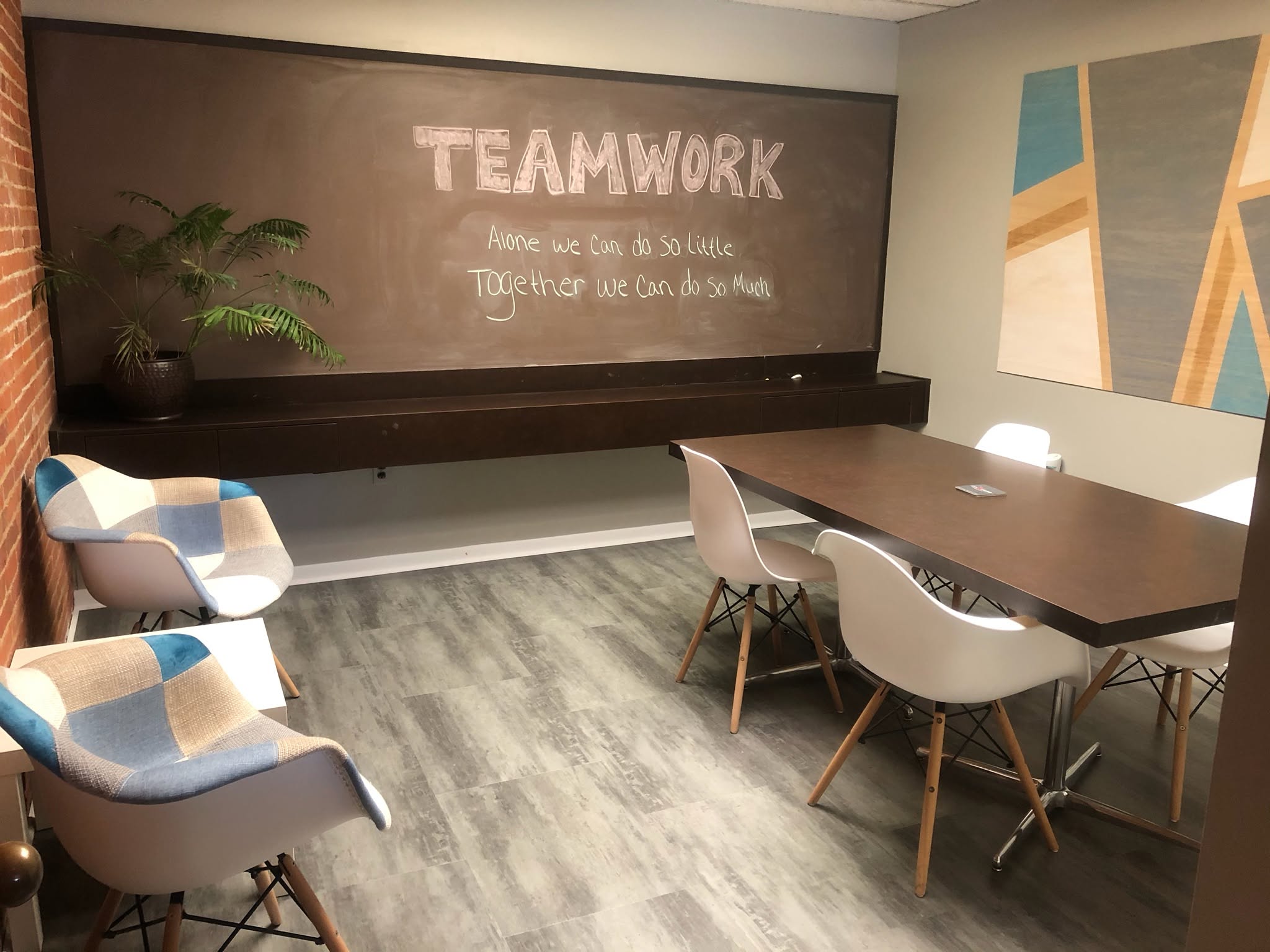 Conference room with chalkboard wall reading Teamwork