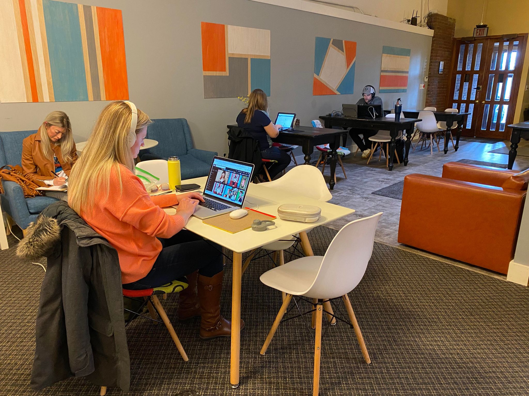 Members working at dedicated desks in the open co-working space